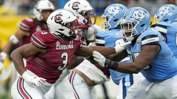 Dec 30, 2021; Charlotte, NC, USA; South Carolina Gamecocks defensive end Jordan Burch (3) tries to evade North Carolina Tar Heels offensive lineman Joshua Ezeudu (75) during the second quarter at Bank of America Stadium.
